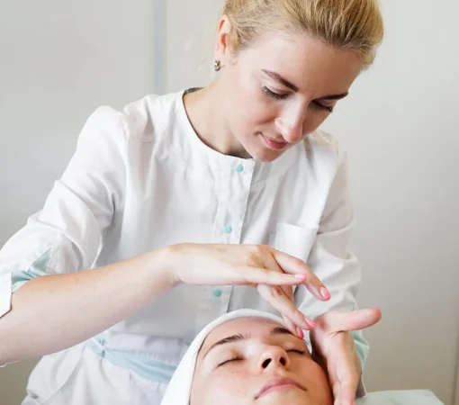 female-beautician-doing-facial-massage-her-female-client-beauty-clinic